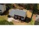 Aerial shot of brick two-story home featuring an attached garage, landscaped front yard and neutral colored roof at 4814 Riveredge Cv, Snellville, GA 30039