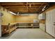 Basement workshop area, featuring pegboard, workbench, and built in storage units at 4814 Riveredge Cv, Snellville, GA 30039