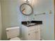 This bathroom features a black marble vanity top, white cabinetry, and brushed gold accents at 4814 Riveredge Cv, Snellville, GA 30039