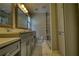 Beautiful bathroom boasting sleek gray cabinets, marble floors, and a glass shower at 4814 Riveredge Cv, Snellville, GA 30039