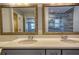 Bathroom vanity featuring a double sink, framed mirrors and contemporary fixtures at 4814 Riveredge Cv, Snellville, GA 30039