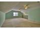 Large bonus room with vaulted ceilings, ceiling fans, and ample space for recreation at 4814 Riveredge Cv, Snellville, GA 30039