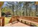 Wooden deck with built-in bench seating, perfect for outdoor relaxation and overlooking the backyard at 4814 Riveredge Cv, Snellville, GA 30039