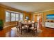 Elegant dining room with hardwood floors, bay window, and stylish furnishings at 4814 Riveredge Cv, Snellville, GA 30039
