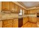 Traditional kitchen featuring wood cabinets, granite counters, and hardwood floors at 4814 Riveredge Cv, Snellville, GA 30039