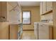 The functional laundry room features a washer, dryer, storage, and natural light at 4814 Riveredge Cv, Snellville, GA 30039