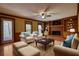 Comfortable living room with brick fireplace, built-in bookshelves, and access to an outdoor patio at 4814 Riveredge Cv, Snellville, GA 30039