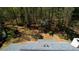 Aerial view showcasing the roof and the heavily wooded backyard at 4814 Riveredge Cv, Snellville, GA 30039