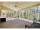 Enclosed sunroom with access to the outside, ceiling fan, and views of the surrounding woods at 4814 Riveredge Cv, Snellville, GA 30039