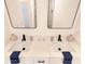 Close up of a bright bathroom vanity with dual sinks, modern faucet fixtures, and neutral decor at 5469 Helen Pl Sw, Mableton, GA 30126