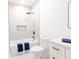 Bright bathroom featuring shower/tub, sleek black hardware, and a single sink vanity at 5469 Helen Pl Sw, Mableton, GA 30126