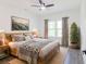 Cozy bedroom with a ceiling fan, light wood furniture, soft area rug, and natural light at 5469 Helen Pl Sw, Mableton, GA 30126