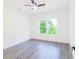 Bright bedroom features a large window view and modern gray flooring at 5469 Helen Pl Sw, Mableton, GA 30126