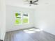 Bedroom featuring double windows providing abundant natural light and wood-look floors at 5469 Helen Pl Sw, Mableton, GA 30126
