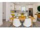 Bright dining room with a table set for six, stylish chairs, modern lighting, and an open flow to the kitchen at 5469 Helen Pl Sw, Mableton, GA 30126