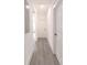 Hallway featuring wood floors, white doors, and neutral paint at 5469 Helen Pl Sw, Mableton, GA 30126