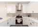 Modern kitchen with white cabinets, stainless steel appliances, quartz countertops, and gray subway tile backsplash at 5469 Helen Pl Sw, Mableton, GA 30126