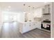 Bright, open kitchen with white cabinetry, stainless steel appliances, and a large island at 5469 Helen Pl Sw, Mableton, GA 30126