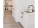 Well-lit laundry area features white cabinets, a sink, and modern fixtures at 5469 Helen Pl Sw, Mableton, GA 30126
