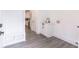 Well-lit laundry area features white cabinets, a sink, and modern fixtures at 5469 Helen Pl Sw, Mableton, GA 30126