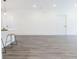 Spacious open-concept living room featuring modern gray flooring and crisp white walls at 5469 Helen Pl Sw, Mableton, GA 30126
