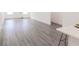 Bright living space with gray laminate flooring, white walls, and large windows providing natural light at 5469 Helen Pl Sw, Mableton, GA 30126