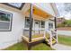 Home's stylish porch with natural wood ceiling and contrasting black trim at 5469 Helen Pl Sw, Mableton, GA 30126