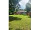 Spacious backyard featuring a wood deck, lush green lawn, and mature trees at 693 Dill Sw Ave, Atlanta, GA 30310