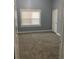 Neutral bedroom with gray walls, plush carpet, window, and white door at 693 Dill Sw Ave, Atlanta, GA 30310