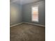 Bedroom featuring carpeted floors, neutral walls, and a bright window at 693 Dill Sw Ave, Atlanta, GA 30310