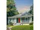 Charming craftsman-style home with a welcoming front porch, a well-manicured lawn, and a vibrant orange front door at 693 Dill Sw Ave, Atlanta, GA 30310