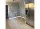 Bright kitchen featuring tiled flooring, stainless steel refrigerator, and gray walls at 693 Dill Sw Ave, Atlanta, GA 30310