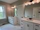 Bathroom featuring dual vanities, sleek mirrors, and ample natural light from the window at 71 Dillard Ne Dr, Kennesaw, GA 30144