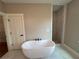 Freestanding bathtub with black fixtures and a walk-in shower nearby at 71 Dillard Ne Dr, Kennesaw, GA 30144