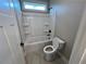 Bathroom with tub, shower, and toilet featuring all-white fixtures at 71 Dillard Ne Dr, Kennesaw, GA 30144