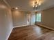 Bedroom features hardwood floors, neutral walls, window with backyard view, and modern light fixture at 71 Dillard Ne Dr, Kennesaw, GA 30144