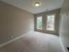 This bedroom features neutral carpet and two windows at 71 Dillard Ne Dr, Kennesaw, GA 30144