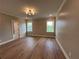 Spacious bedroom with hardwood floors, modern lighting, and two windows with outside views at 71 Dillard Ne Dr, Kennesaw, GA 30144
