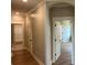 Hallway displaying beautiful hardwood floors, white trim, and neutral wall paint at 71 Dillard Ne Dr, Kennesaw, GA 30144