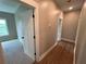 Hallway with hardwood floors leading to a bedroom and other rooms at 71 Dillard Ne Dr, Kennesaw, GA 30144