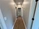 Hallway featuring wood flooring that connects to various rooms and a walk-in closet at 71 Dillard Ne Dr, Kennesaw, GA 30144