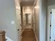 Hallway featuring neutral walls, white trim, and a glimpse into a closet at 71 Dillard Ne Dr, Kennesaw, GA 30144