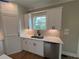 Bright kitchen features white cabinetry, stainless steel dishwasher, and a window view at 71 Dillard Ne Dr, Kennesaw, GA 30144