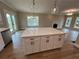 Open-concept kitchen with island, flowing into living area with fireplace and lots of natural light at 71 Dillard Ne Dr, Kennesaw, GA 30144