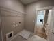 Well-lit laundry room with tile floors and connections for appliances at 71 Dillard Ne Dr, Kennesaw, GA 30144