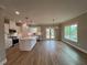Open concept living space showcases hardwood flooring, bright lighting, and kitchen access at 71 Dillard Ne Dr, Kennesaw, GA 30144