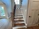 Inviting staircase featuring wood treads, white risers, and an elegant dark metal railing at 71 Dillard Ne Dr, Kennesaw, GA 30144