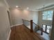 View of upstairs hallway with wood floors, iron railing and doors leading to outside at 71 Dillard Ne Dr, Kennesaw, GA 30144