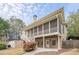 Spacious two-story home exterior with a large screened porch, lower patio, and stairs to backyard at 7415 Northampton Ct, Cumming, GA 30040