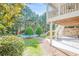 Multi-tiered backyard featuring a pool, mature trees, and a covered patio at 7415 Northampton Ct, Cumming, GA 30040